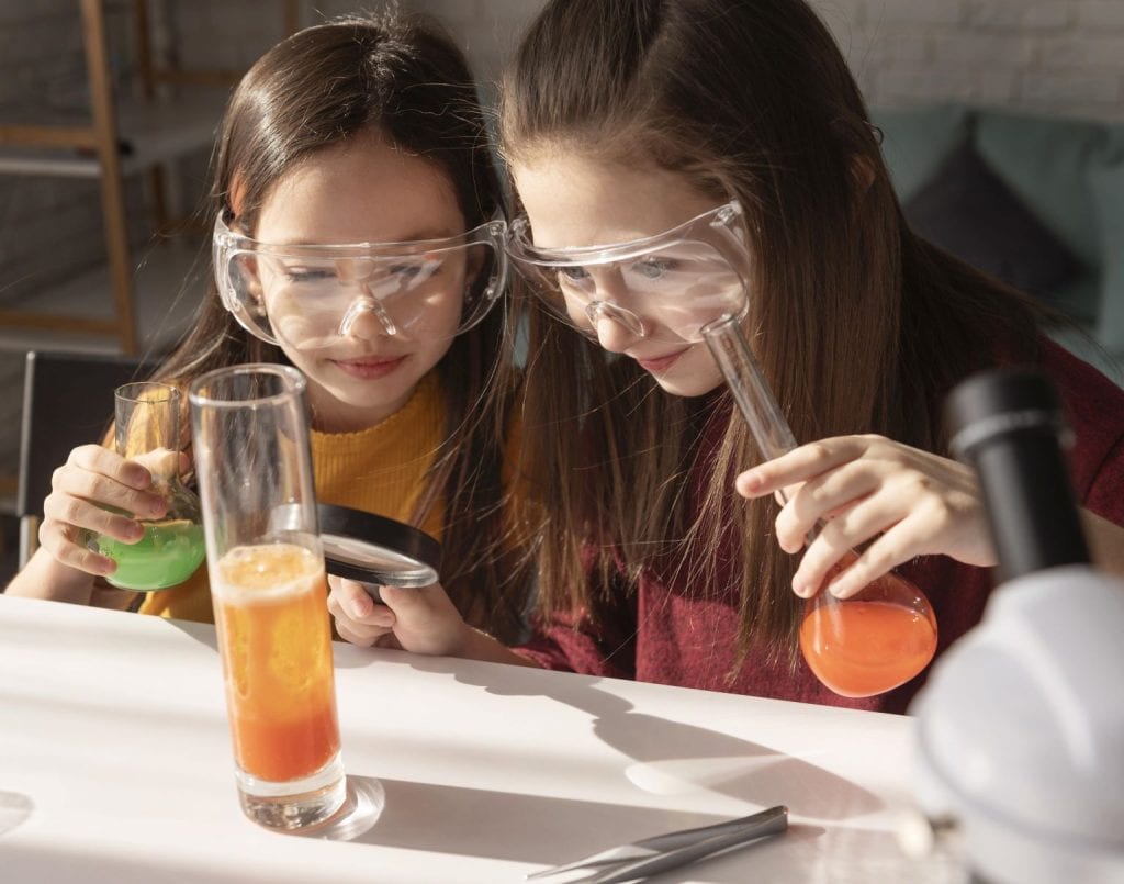 Girls Holding Flasks Learning Chemistry