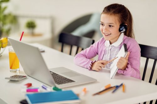 Motivated young girl in an online school